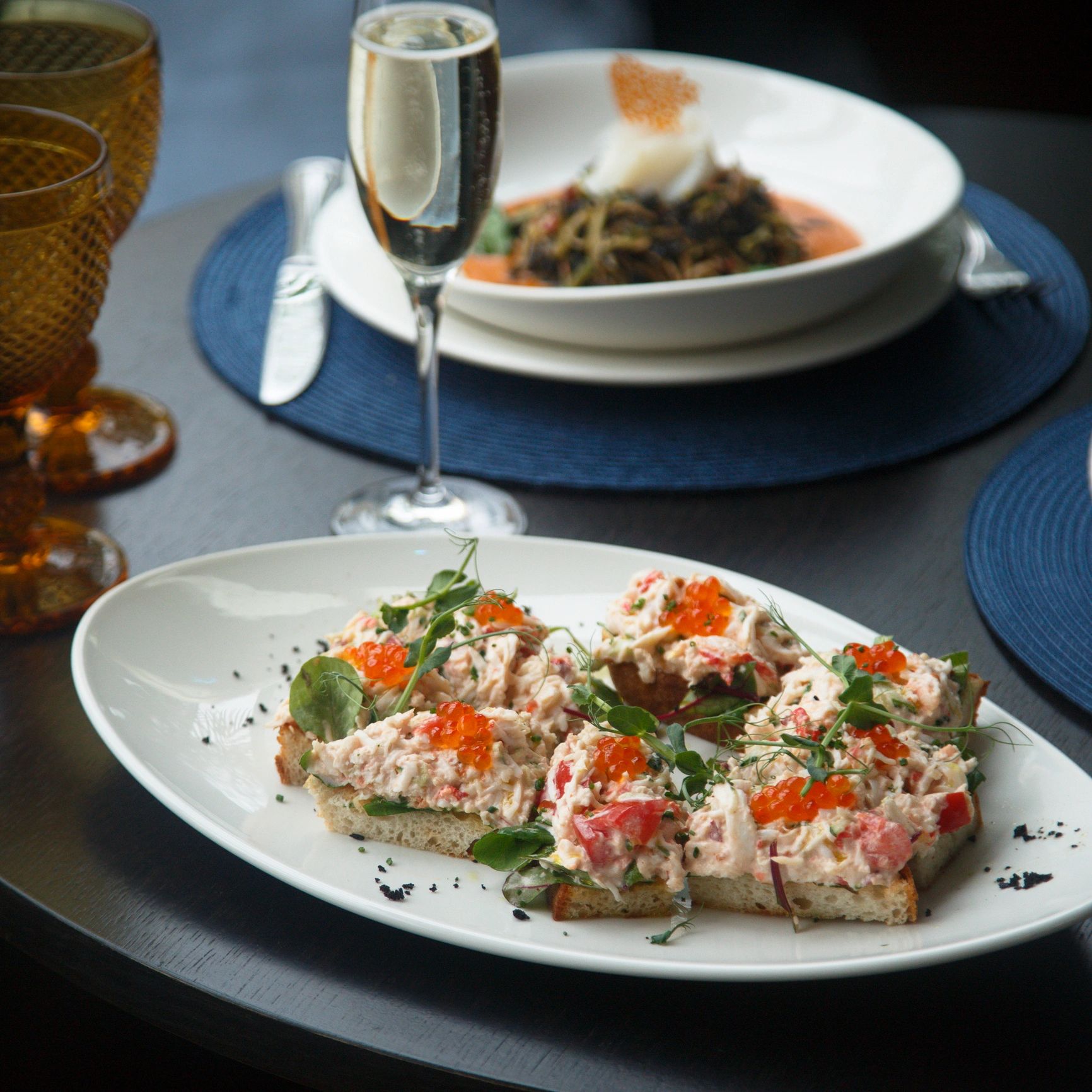 Crab caviar bites presented on toast